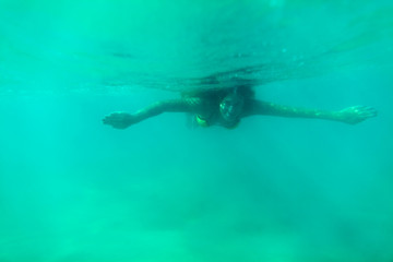 woman swim underwater turquoise blue lagoon