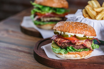 Fresh burger in bun with sesame with lettuce, tomato, beef and bacon.