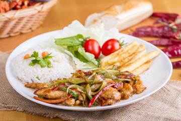 original fajita sizzling smoking Chicken breast with vegetables and sauce decorated with basil leaves