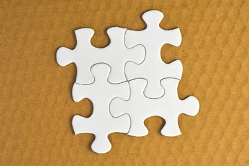 Jigsaw puzzle on brown background