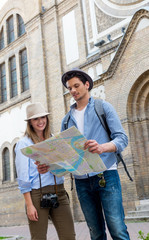Tourists sightseeing city with map