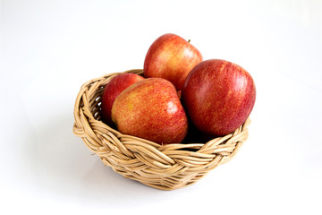 Red apple in basket on white background