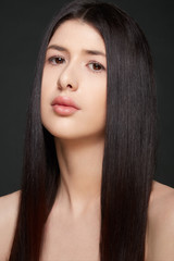 Young woman beauty with long, dark straight hair