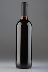 Red wine bottle on gray background, clipping path