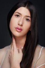 Young woman beauty with glossy pink lipstick and dark straight hair
