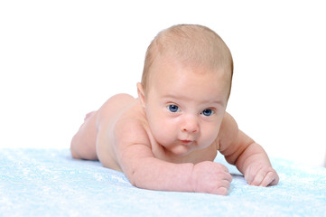 A Newborn Baby Trying to Crawl on a Blue Blanket