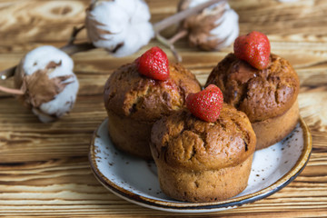 Fototapeta na wymiar Homemade sweet muffins with strawberries and chocolate