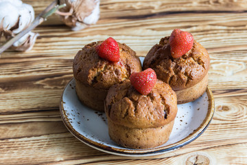 Homemade sweet muffins with strawberries and chocolate