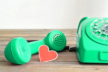 Father's Day card: Vintage telephone and heart  shaped tag on wooden background