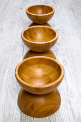 Top view of wooden bowl on wooden background