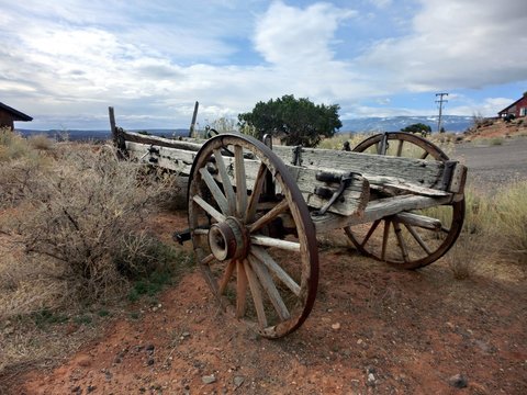 Old fashioned antique wooden cart outdoors in the western prairie - landscape color photo