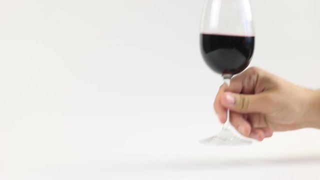 Man  drink red wine. Studio setting on a white background. High definition video