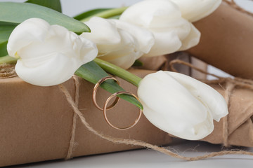 Gift box and tulips bouquet on white background