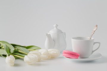 White tulips with tea and sweets