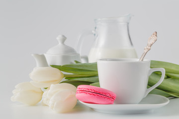 White tulips with tea and sweets