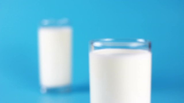 A glass of milk on blue background