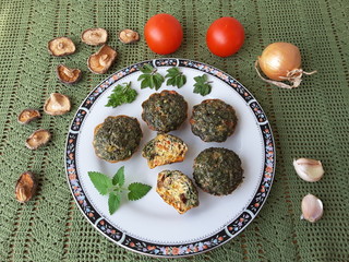 Goutweed omelette on plate with mushrooms shiitake, tomato and onion