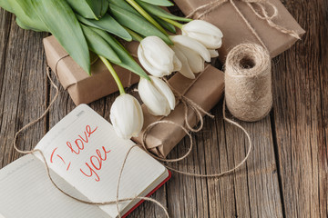 I love you phrase in notebook with flowers on table