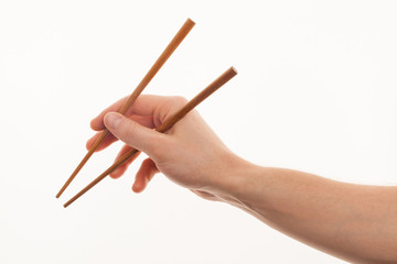 isolated man hand holding wooden chopstick