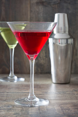  cocktails and shaker on rustic wooden table

