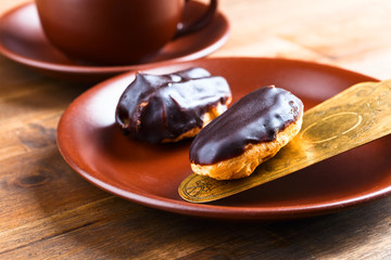 French eclair on wooden table