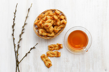 Homemade puff pastry. Plait cookies and cup of tea. Top view.