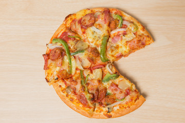 Pizza with sliced vegetables on wood