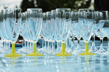 Rows of empty glasses on table at a party outdoors