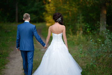 Newlyweds walk and hold hands