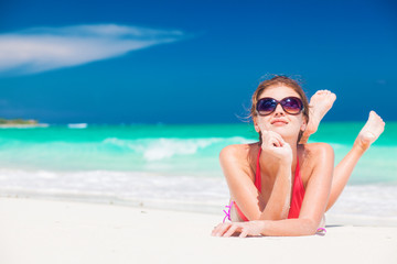 portrait of woman in bikini relaxing on tropical beach