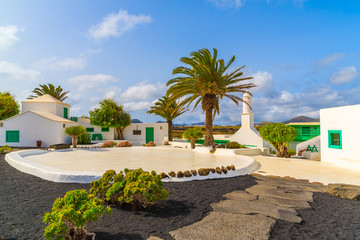 Fototapeta na wymiar Typical Canarian style buildings and tropical plants, El Campesino village, Lanzarote island, Spain