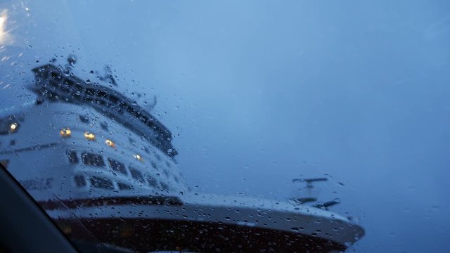 View from car on ferry ship with raindrops
