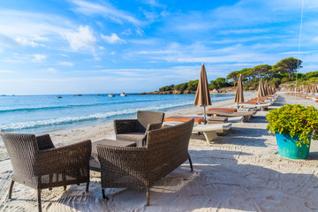 Fototapeta na wymiar Chairs with table on sandy Palombaggia beach, Corsica island, France