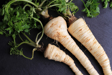 Parsnip on black background. Cooking, Healthy eating concept.