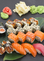 Traditional Japanese food - sushi, rolls and nigiri over black background