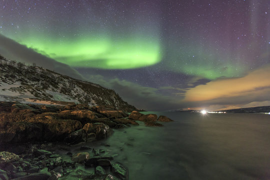 Northern Lights on the icy sea of Svensby, Lyngen Alps, Troms, Lapland