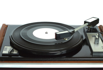 Old vintage three speed turntable in wooden case with rotation vinyl record with white label isolated on white background. Horizontal photo front view closeup
