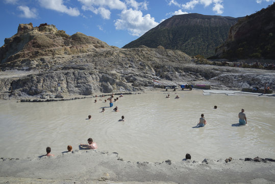 Bathers enjoying the therapeutic benefits of the volcanic mud in the hot spring pool, Vulcano Island, Aeolian Islands, north of Sicily, Mediterranean