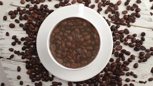 Morning coffee. Coffee magic. Roasted coffee beans turn into fragrant drink.