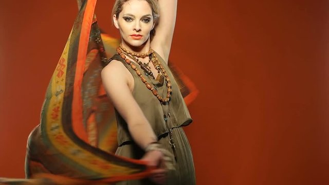 pretty woman portrait with makeup playing with the scarf