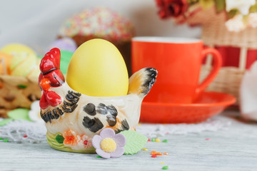 Table setting for Easter - Easter cakes, coffee cup and colored