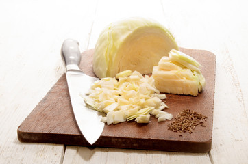 chopped white cabbage on a wooden board