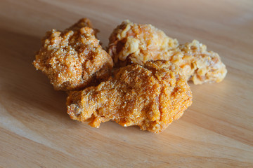 Fresh fried chicken on wood background