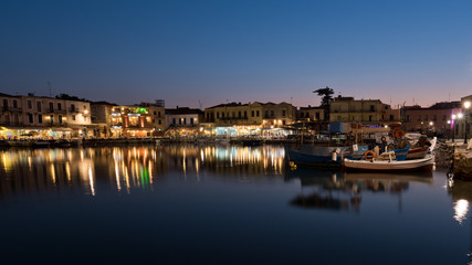 Fototapeta na wymiar The venetian harbor of Retymno with lots of restaurants at the pier.