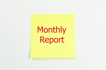 Hand underlining monthly report with blue marker on transparent wipe board.