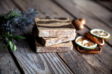 Natural cosmetics. Organic scrub soap on wooden background. Purification, healthy skin and a beautiful body. Lavender and citrus.