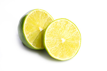 Fototapeta na wymiar Sliced fresh limes on on white, DOF