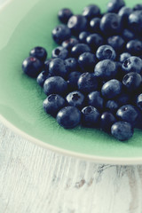 blueberry on wooden surface
