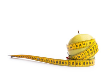 Fresh and green organic apple with metering tape on white