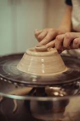 child working on potter's wheel